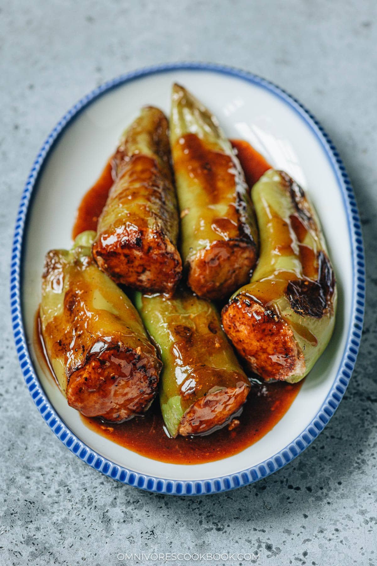 Chinese stuffed peppers served in a plate with brown sauce