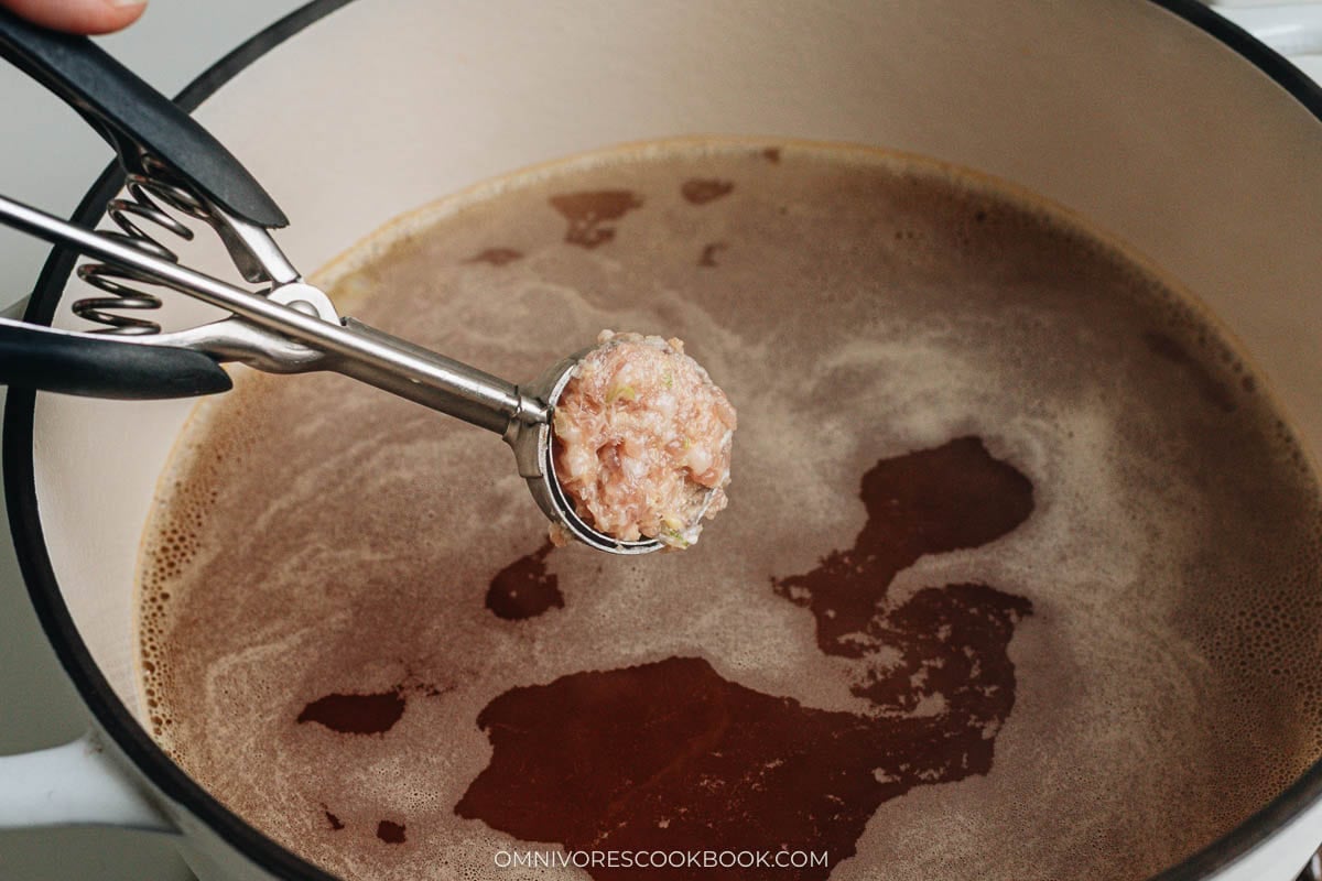 Adding meatballs into the broth