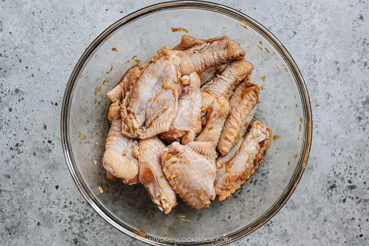 Marinated wings after resting, coated evenly with the savory marinade and ready to be battered.