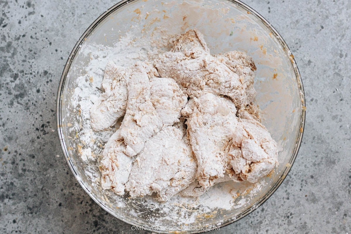 Wings tossed with cornstarch, covered in a light, powdery coating before frying.