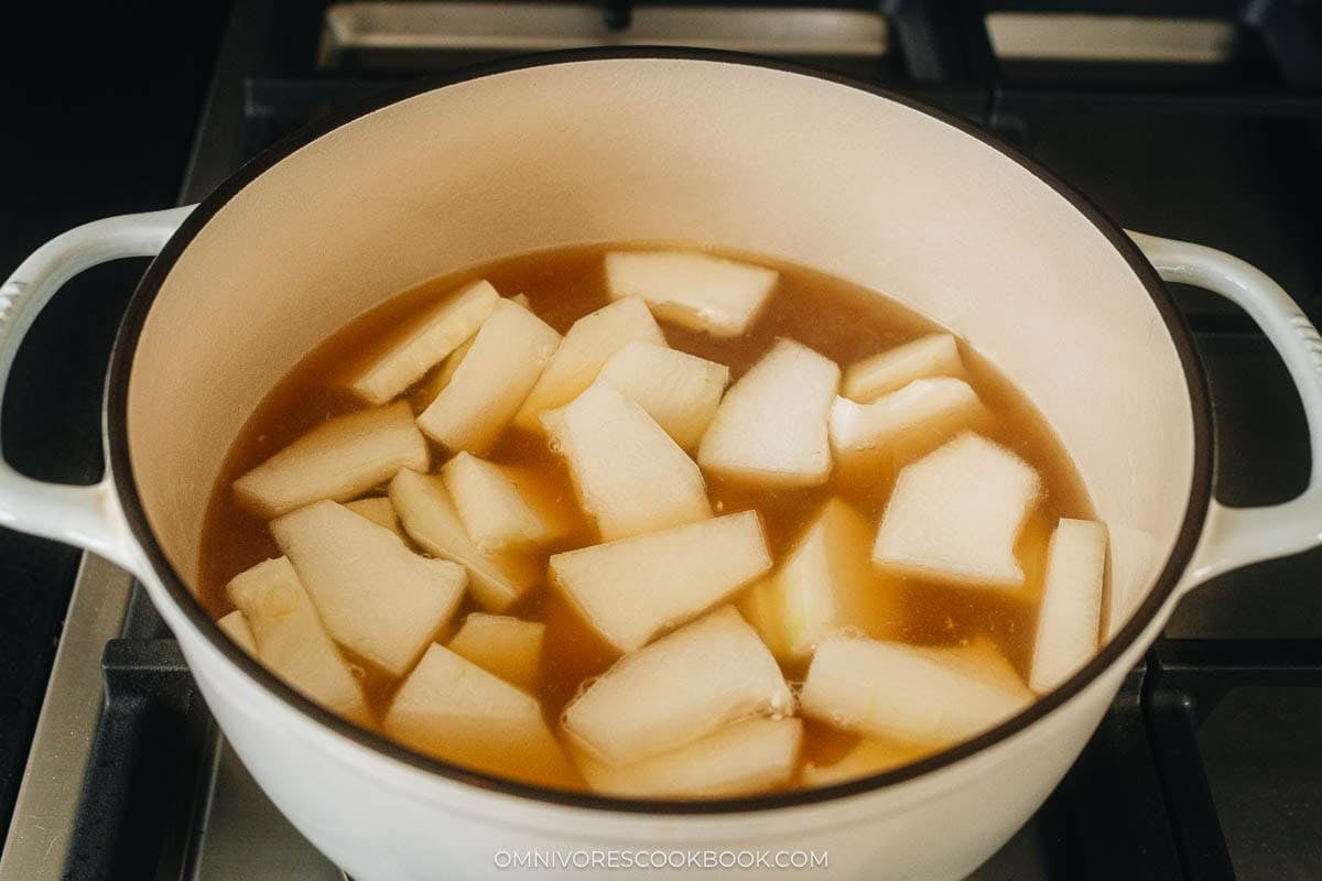 Large chunks of winter melon simmer in a pot of clear broth