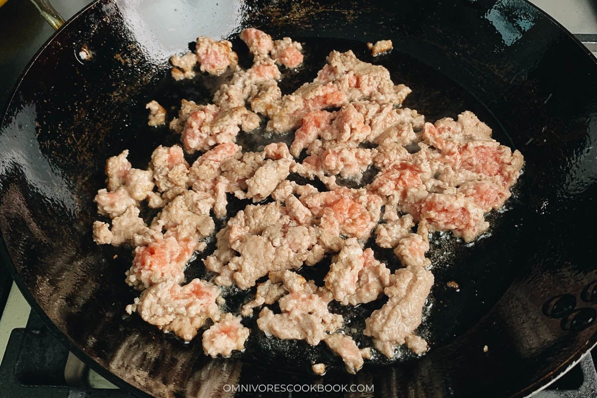 Browning the pork in carbon steel pan