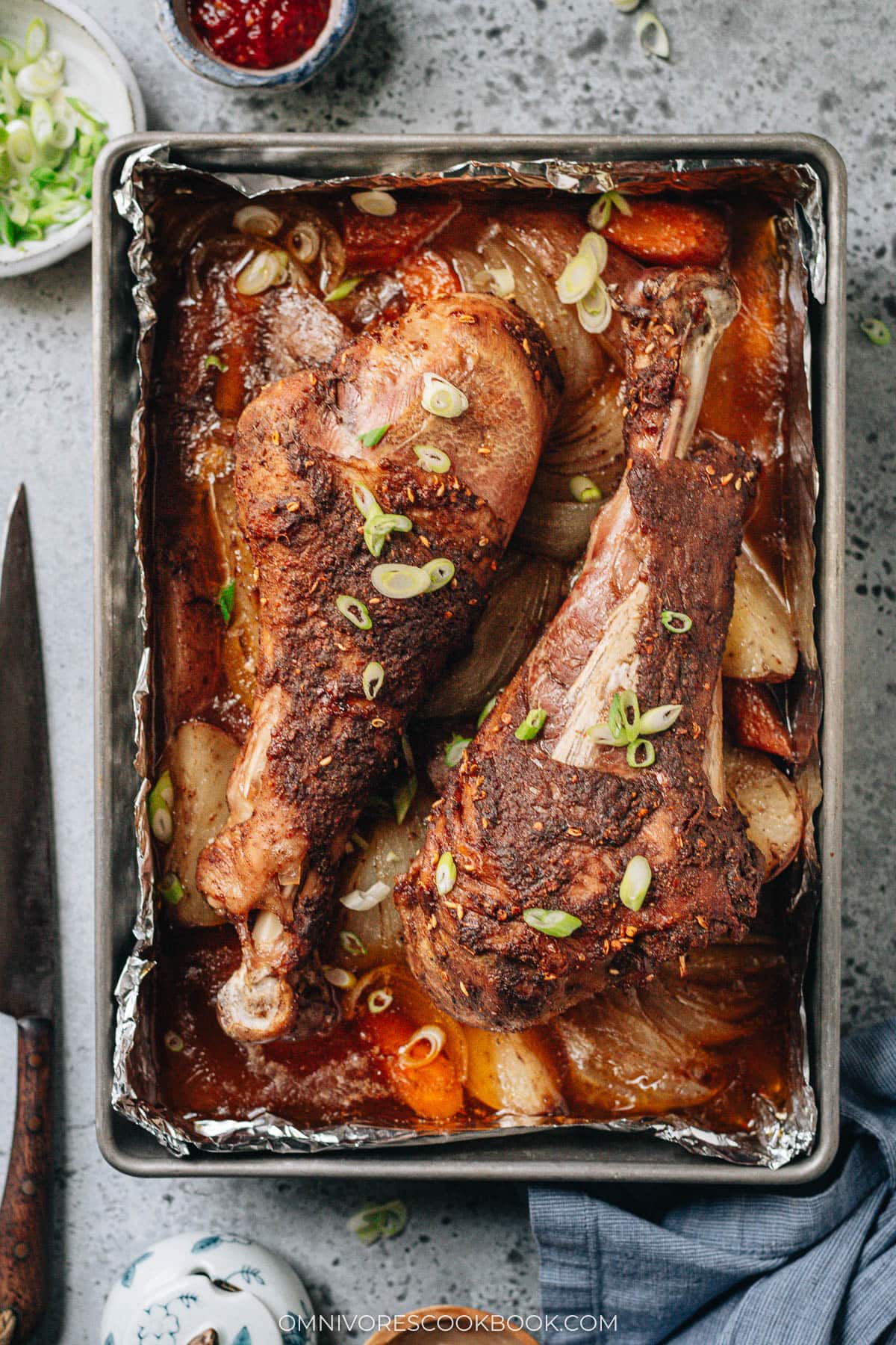 Roast turkey legs over a bed of vegetable