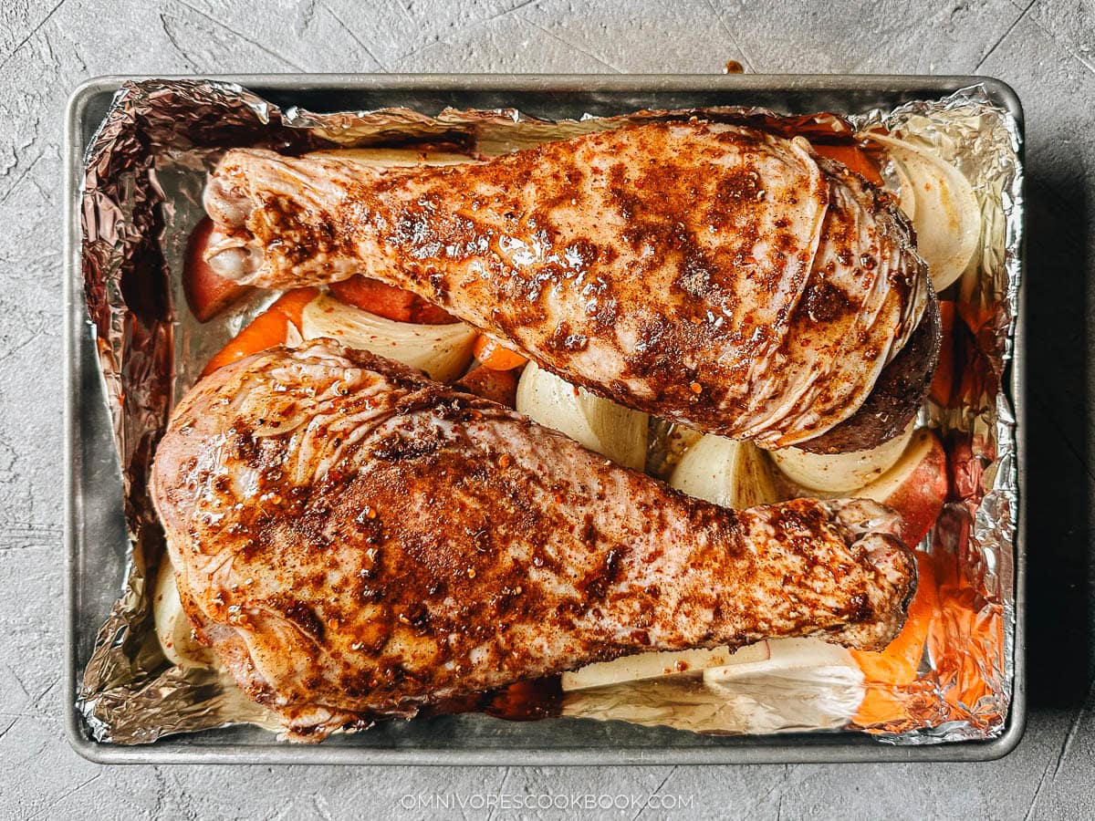two turkey legs on the bed of vegetables