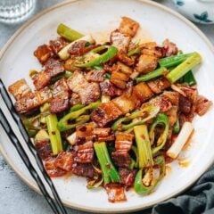 My twice cooked pork recipe walks you through all the ingredients and steps to recreate the authentic tasting dish just like you’d get at a restaurant. Crispy pork belly tossed in a rich spicy savory sauce with scallion and chili pepper: a scrumptious dish that’s rich and balanced. It’s easy enough to cook on a weeknight yet festive enough to serve for a dinner party.