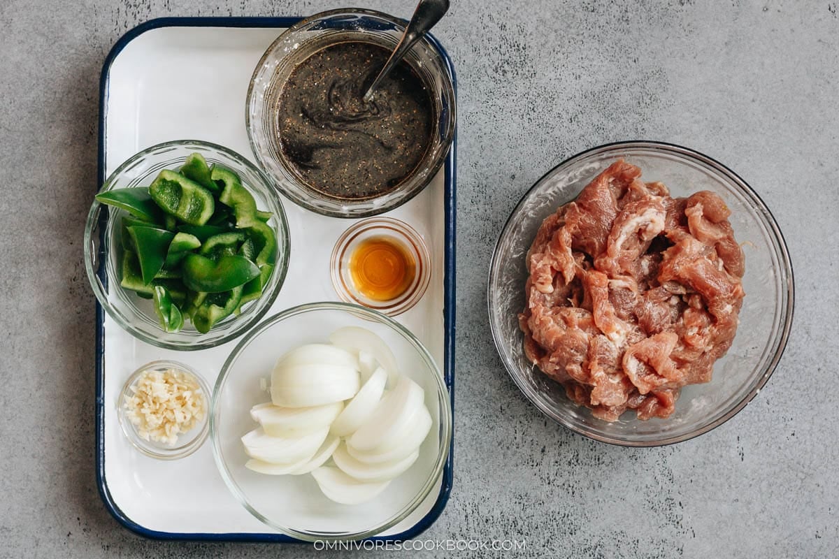 Ingredients for pork and pepper stir fry arranged in bowls