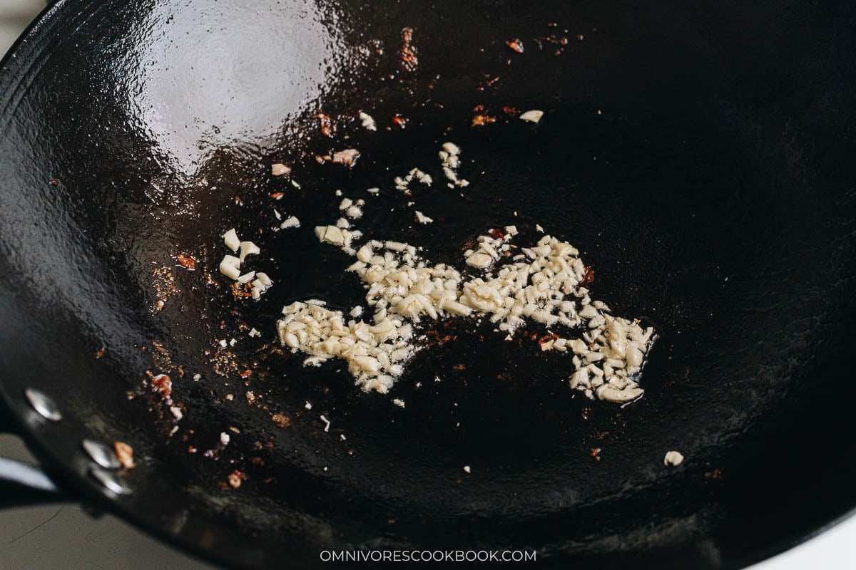 Minced garlic sautéing in hot wok oil