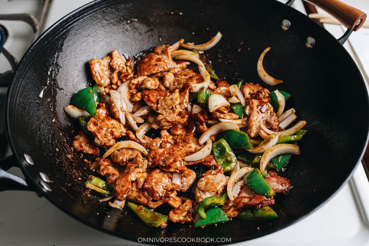 Pork returned to the wok with vegetables and sauce to finish cooking