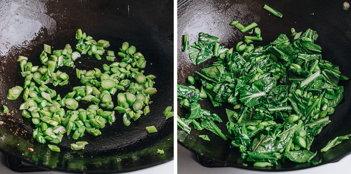 Stir frying choy sum leaves and stems in a wok.
