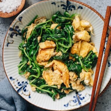Chinese spinach and egg stir fry on a ceramic plate
