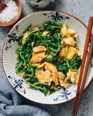Chinese spinach and egg stir fry on a ceramic plate