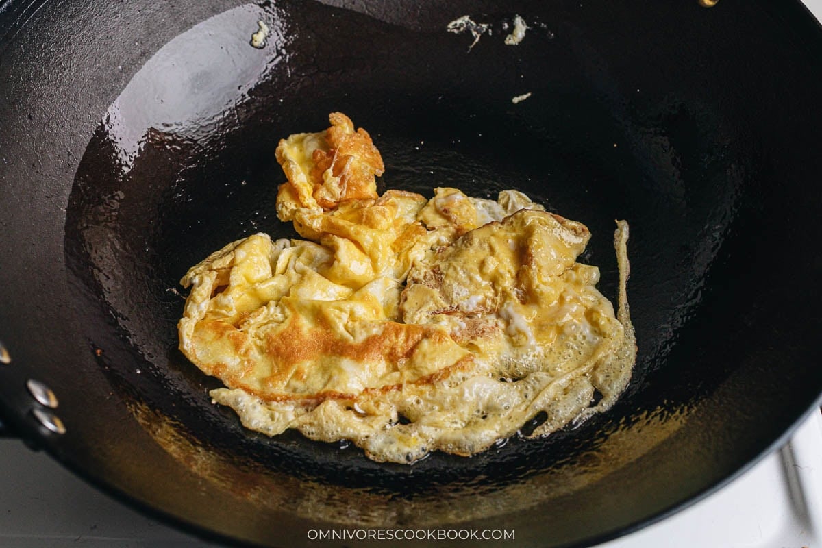Scrambled eggs cooking in a wok