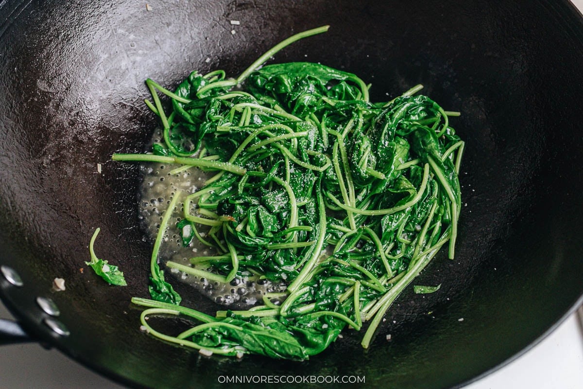 Spinach wilting in a wok