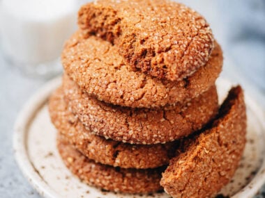 Stack of Sichuan peppercorn gingersnap cookies with crackly tops on a plate