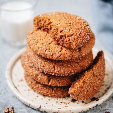 Stack of Sichuan peppercorn gingersnap cookies with crackly tops on a plate
