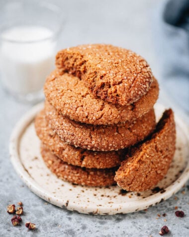 Stack of Sichuan peppercorn gingersnap cookies with crackly tops on a plate