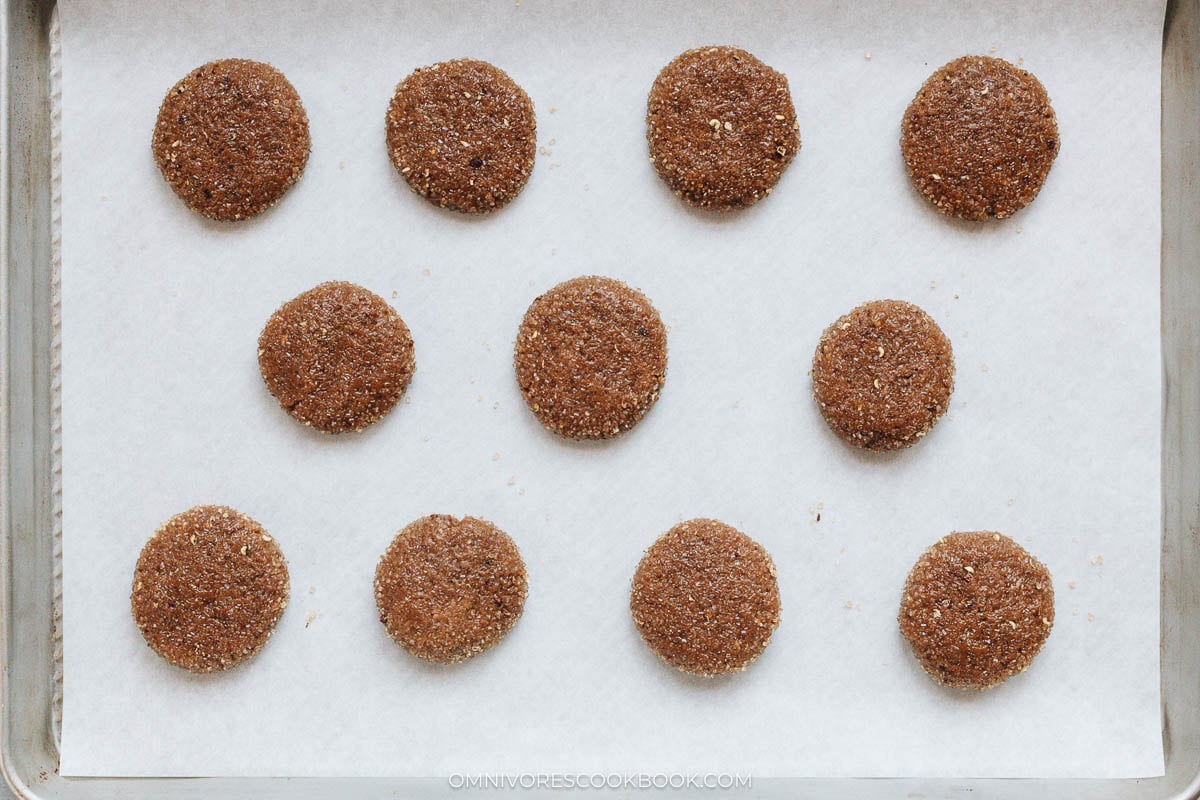 Cookie doughs ready to bake on a lined sheet pan
