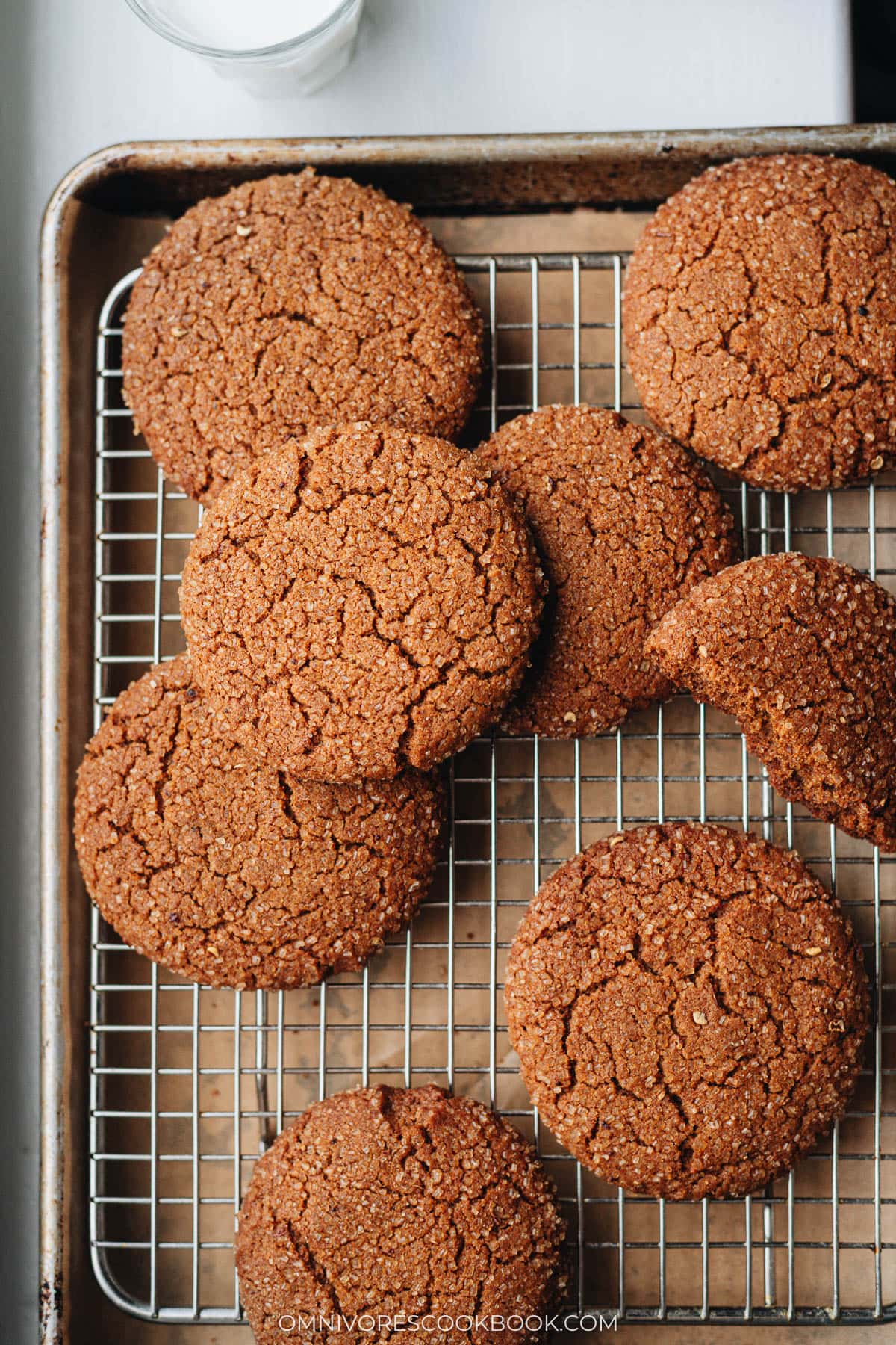 Sichuan peppercorn gingersnap cookies cooling on a wire rack after baking
