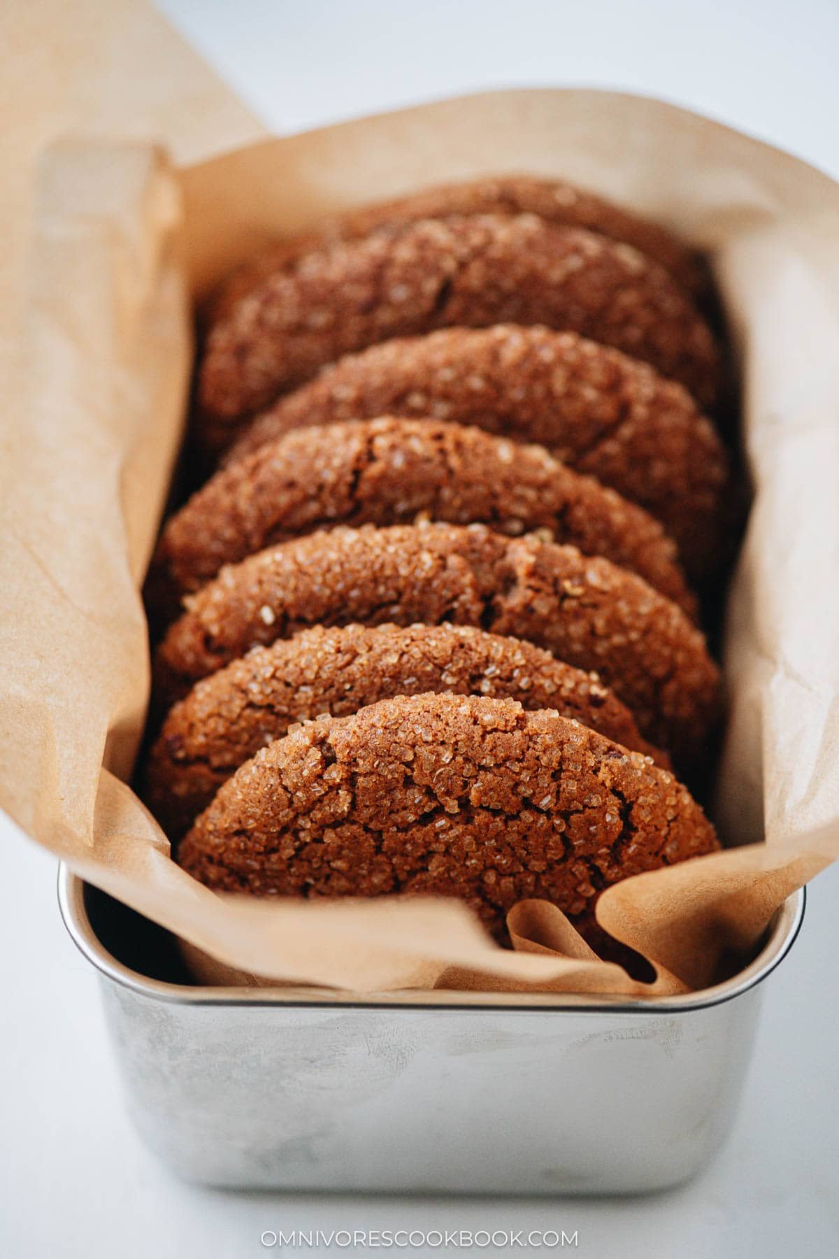 Close-up of gingersnap cookies arranged in a gift tin for the holidays
