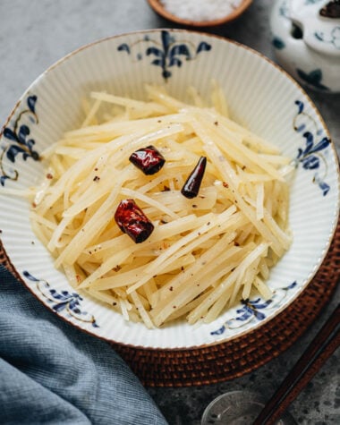 Close-up of Chinese shredded potato salad with dried chili on top