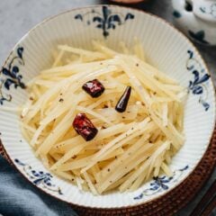 My mom&rsquo;s Chinese potato salad recipe creates a crisp and fragrant appetizer that is completely different from the creamy Western-style versions you might be used to. Thinly shredded potatoes are lightly blanched, then dressed in hot oil infused with garlic, Sichuan peppercorn and dried chili, creating a dish that&rsquo;s aromatic and refreshing.