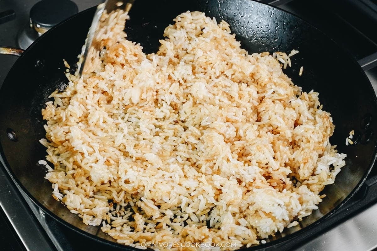 Toast the rice with hot oil and soy sauce