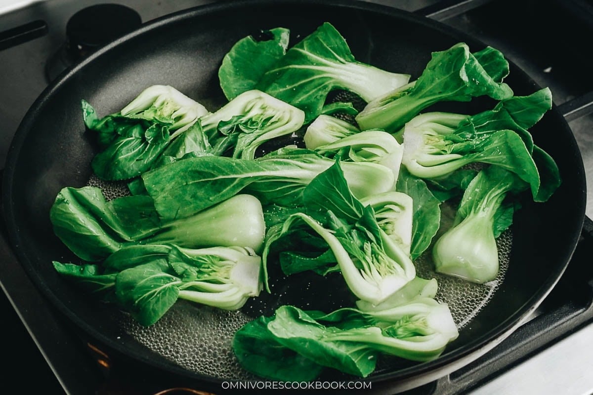 Steam the baby bok choy with a bit of water in the pan