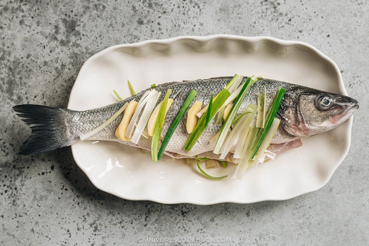 Stuff fish with sliced ginger and green onions