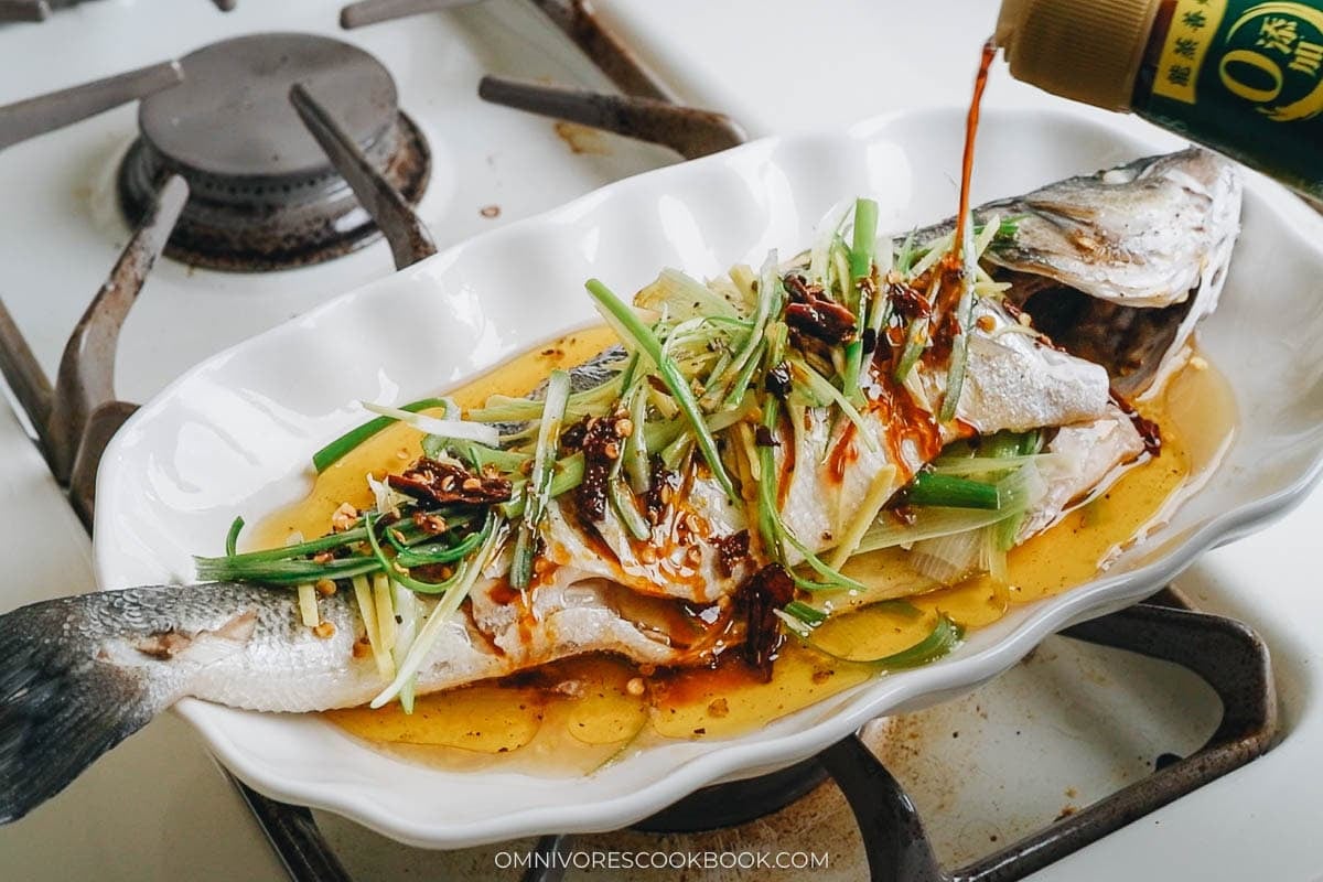 Pouring soy sauce directly over the fish 