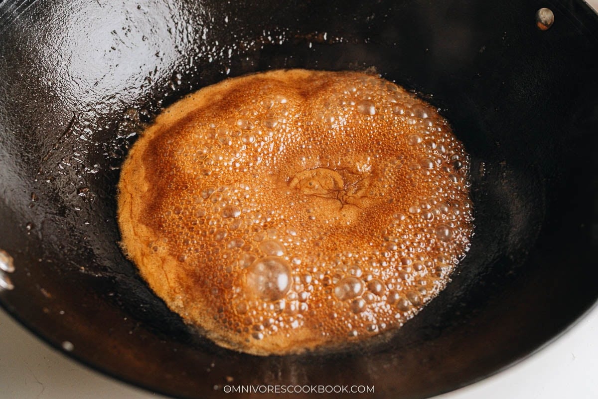 Soy sauce braising liquid bubbling in a wok