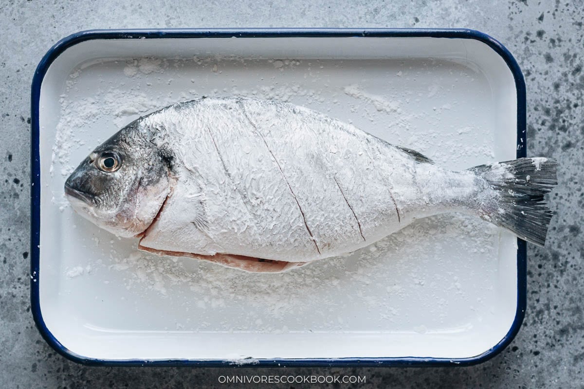 Whole fish coated with cornstarch before pan frying