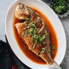 My mom&rsquo;s Chinese braised whole fish uses a simple set of ingredients and merely 30 minutes to create a festive main dish. The dish is pan fried, then quickly braised in a soy sauce based sauce to create a tender texture with a balanced and aromatic flavor. It&rsquo;s a perfect dish for Sunday dinner or Chinese New Year.
