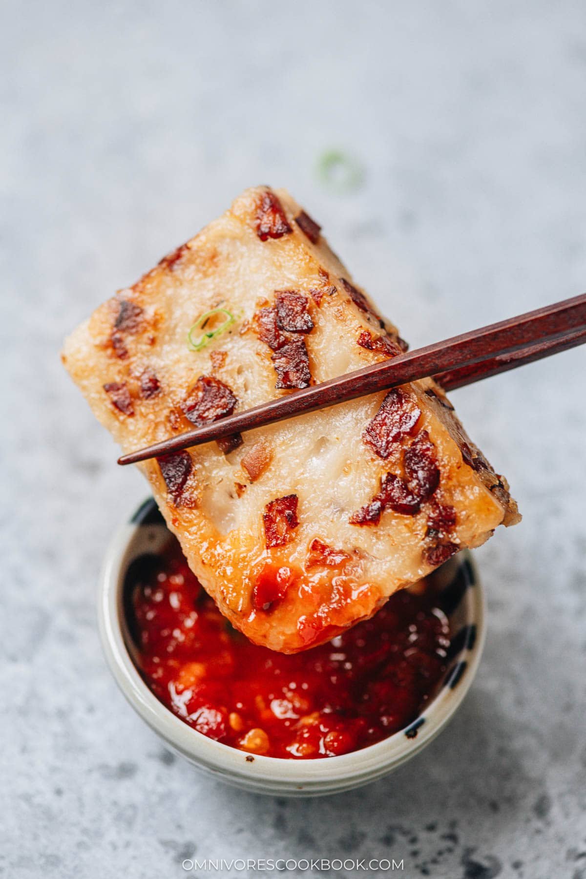 piece turnip cake on chopsticks