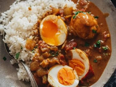 Egg curry served with steamed rice in a bowl