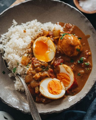 Egg curry served with steamed rice in a bowl