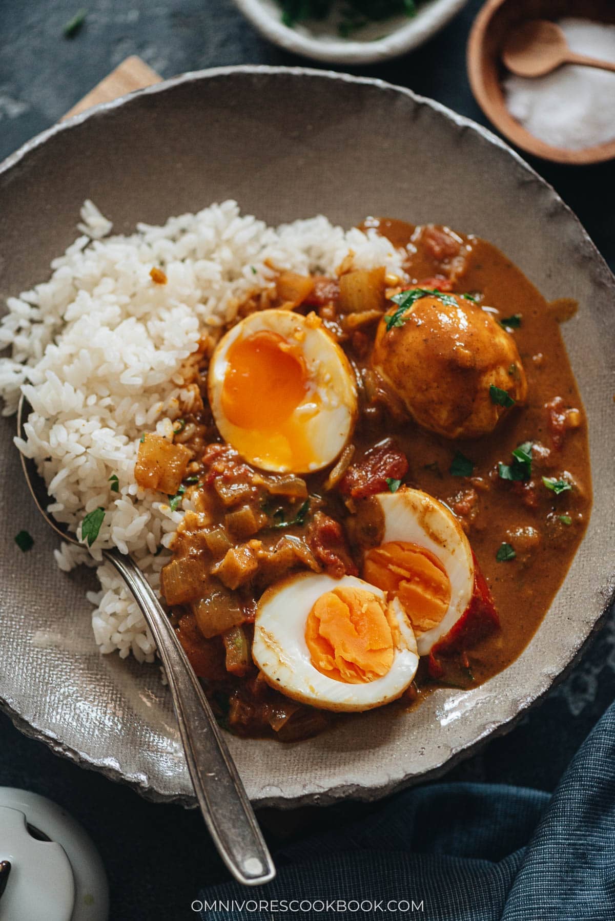 Egg curry served with steamed rice in a bowl