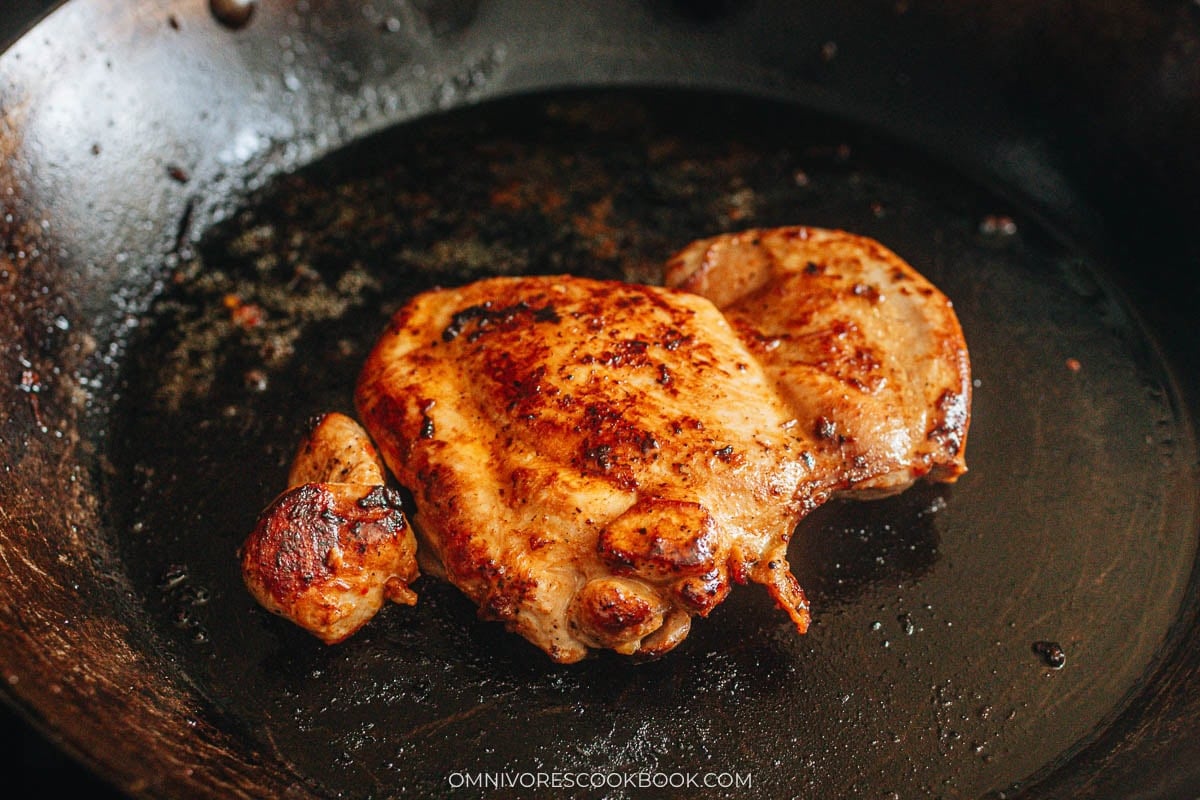 cooking the chicken in a pan