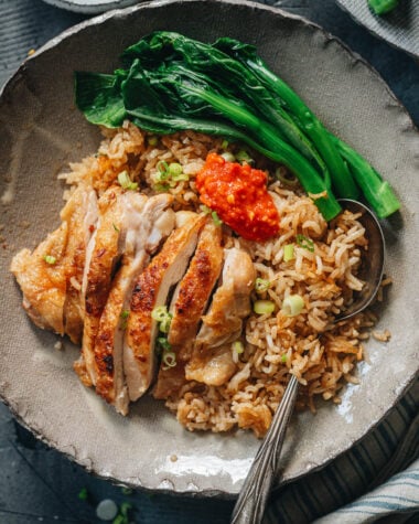 Carved chicken served on rice with Chinese broccoli