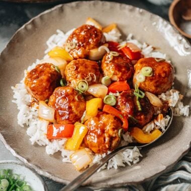Meatballs with sweet and sour glaze over rice