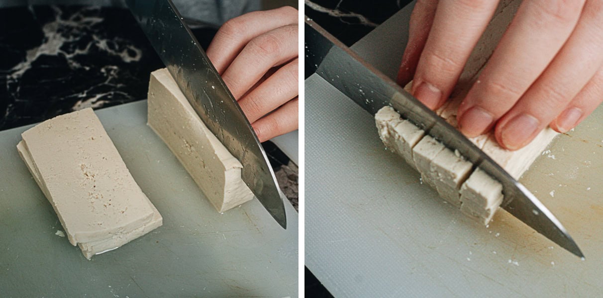 Soft tofu being sliced on a cutting board.