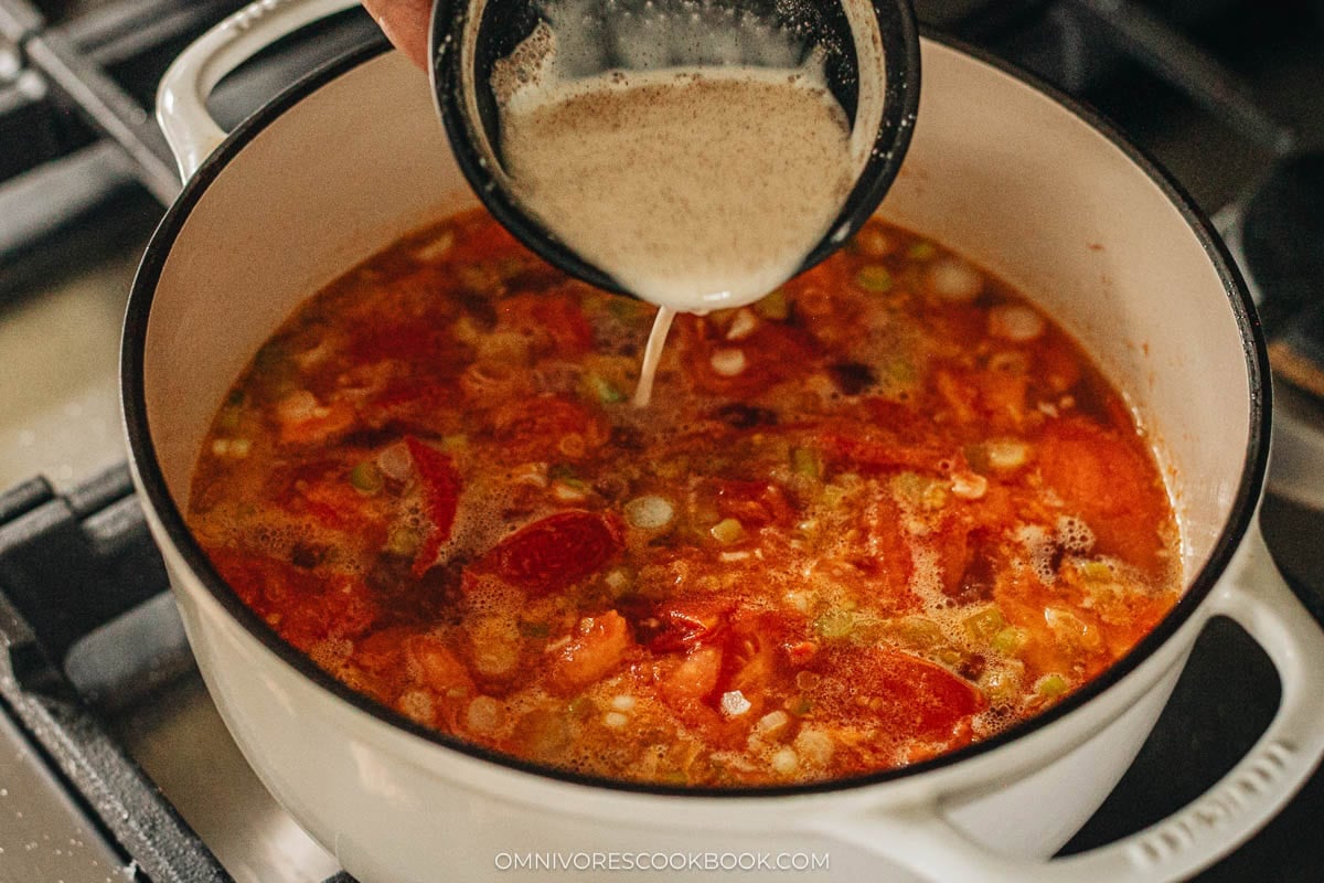 Adding the cornstarch slurry to broth mixture