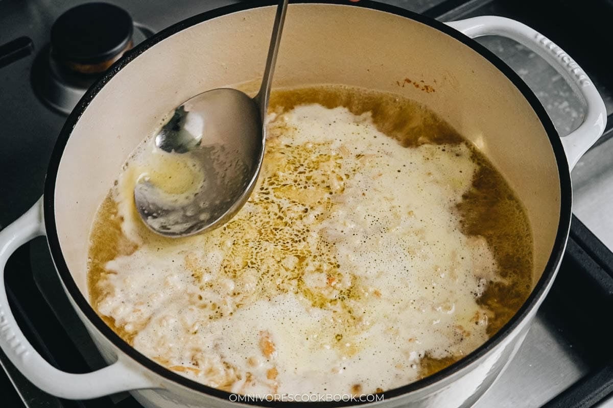 Add the chicken broth and ginger, then bring to a boil