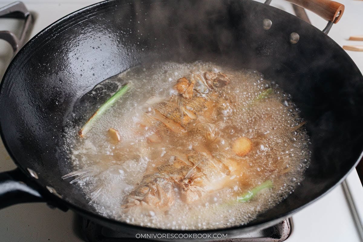 Fish soup boiling in wok