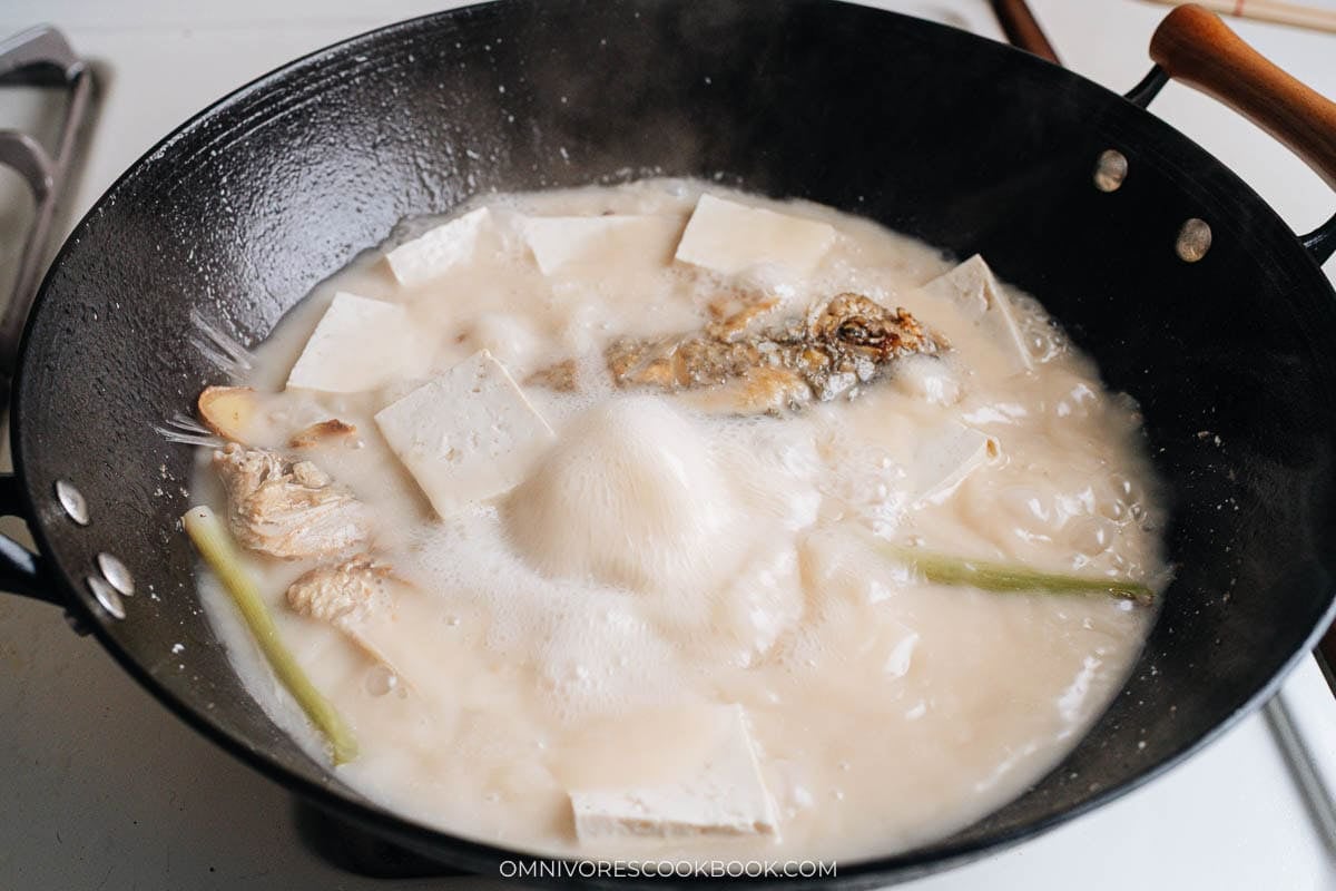 Cooking Chinese fish soup in wok