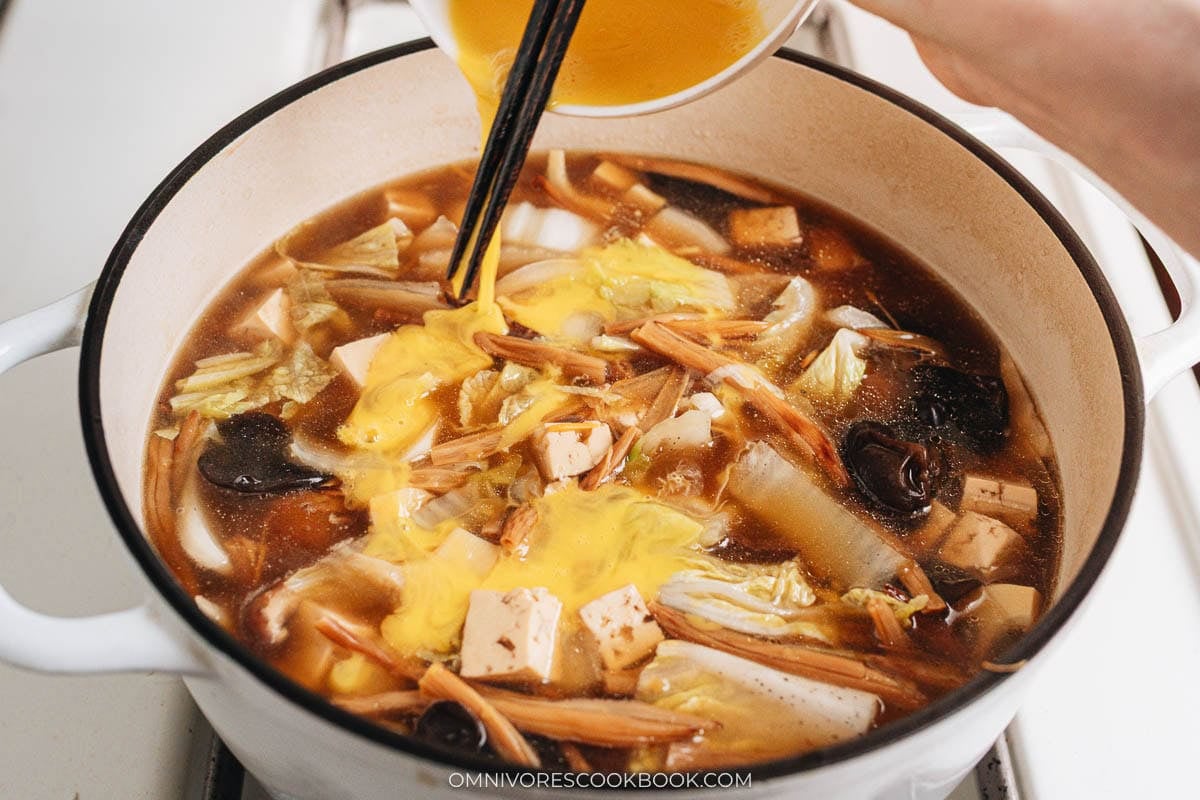 adding eggs  to the soup