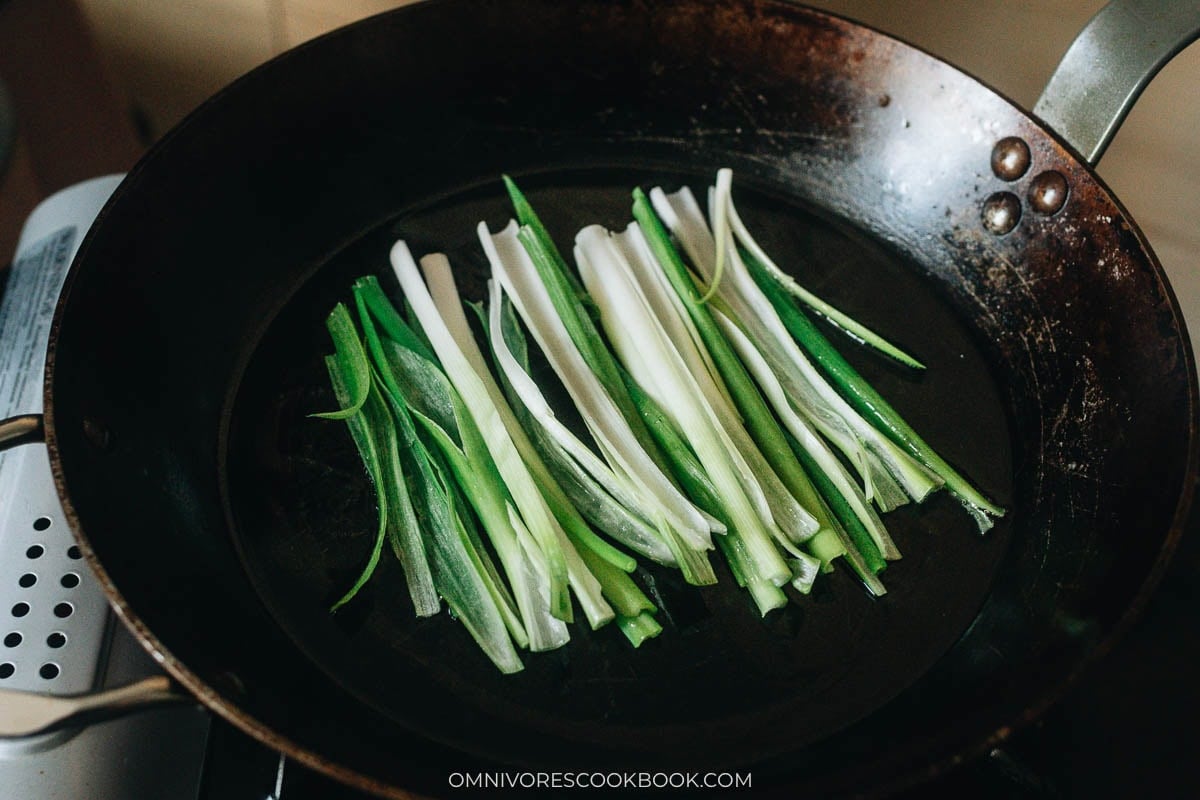 spread out green onion in the heated pan