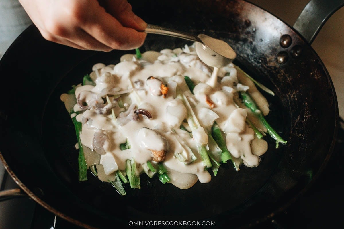 Adding another layer of batter to cover the seafood