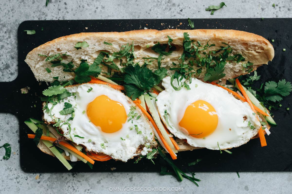 garnishing sandwich with cilantro