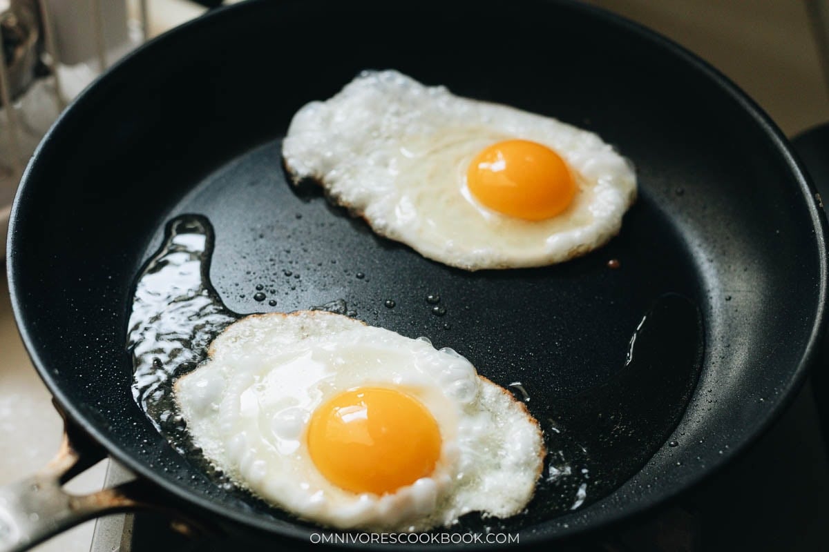 frying two eggs in a pan