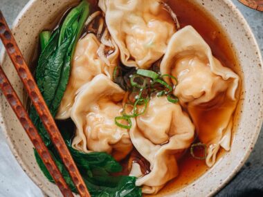 Bowl of shrimp wonton soup with wontons in clear broth
